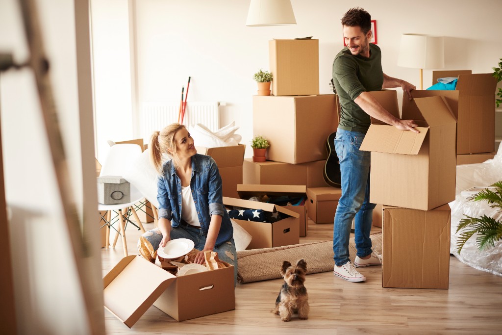Students packing boxes in an apartment